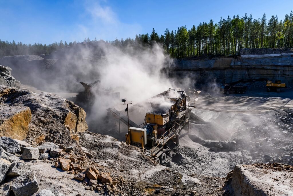 Excavation machinery in a dust-filled quarry in Honkajoki, Finland.