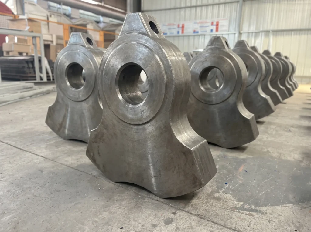 high-manganese-crusher-hammers-row-display High manganese hammer crusher wear parts ready for installation